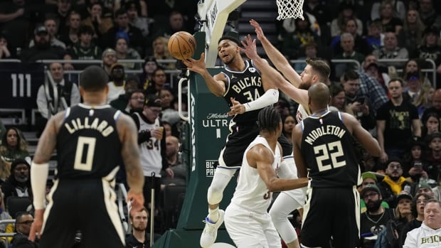 January 26, 2024; Milwaukee Bucks forward Giannis Antetokounmpo passes the ball to guard Damian Lillard at Fiserv Forum